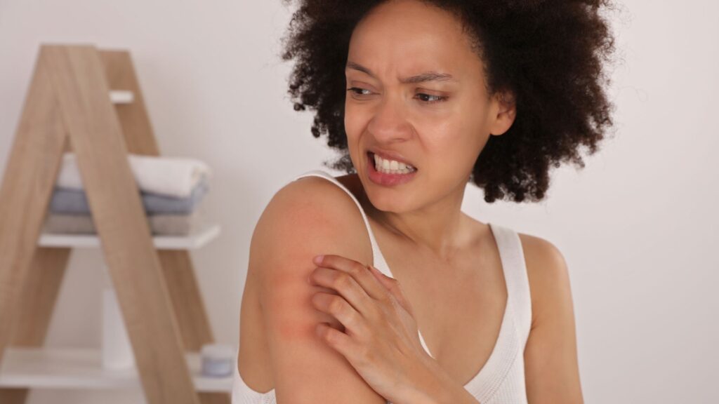 woman itching arm